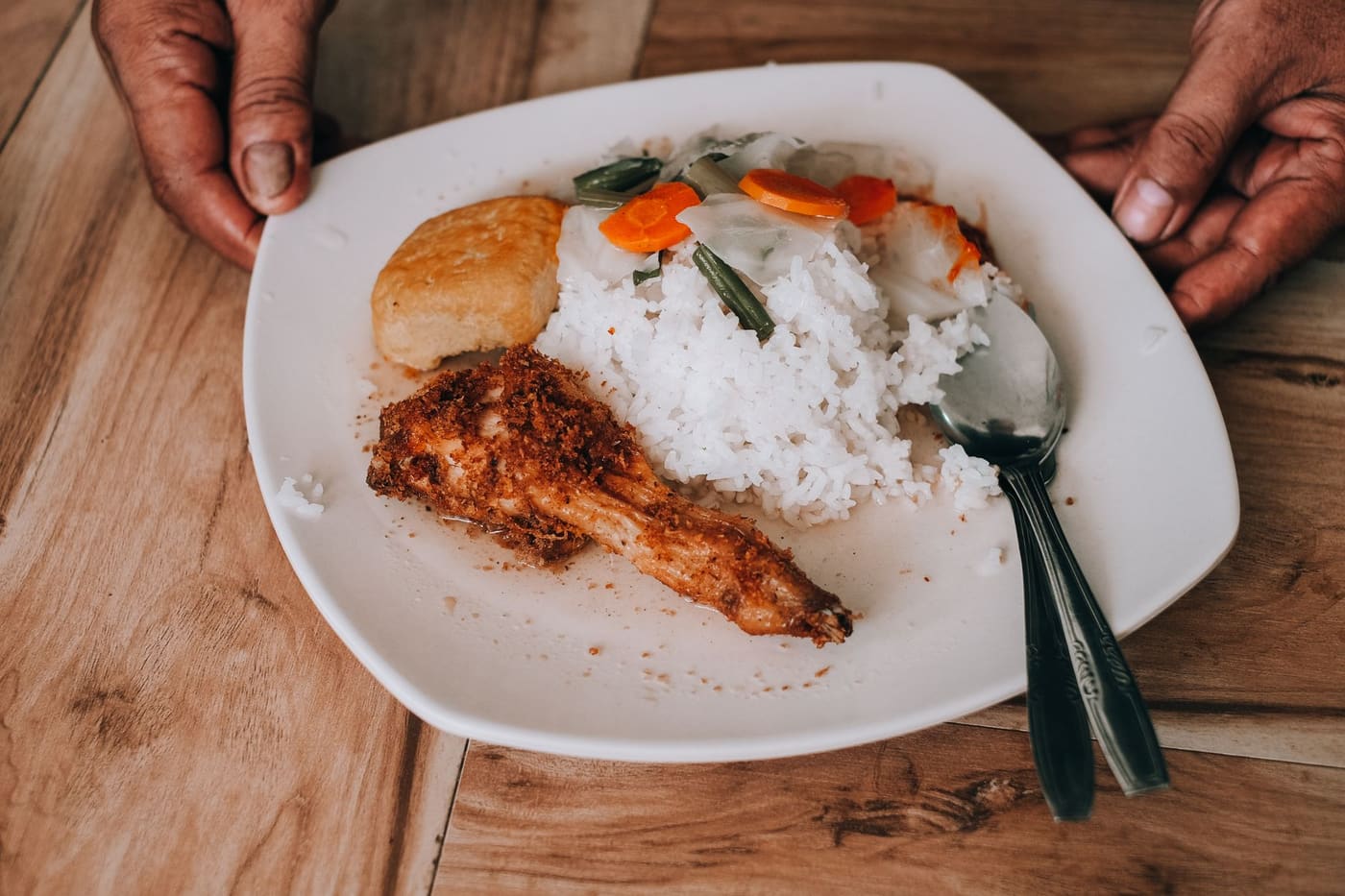 Grilled chicken breast, rice and vegetables on a white plate
